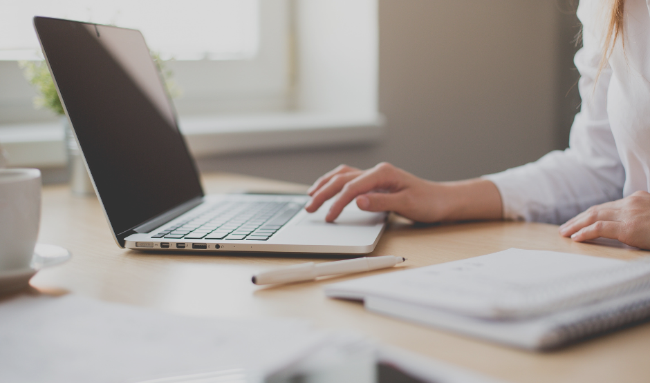 A person typing on a laptop