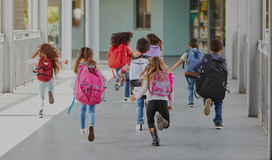 Children running with backpacks