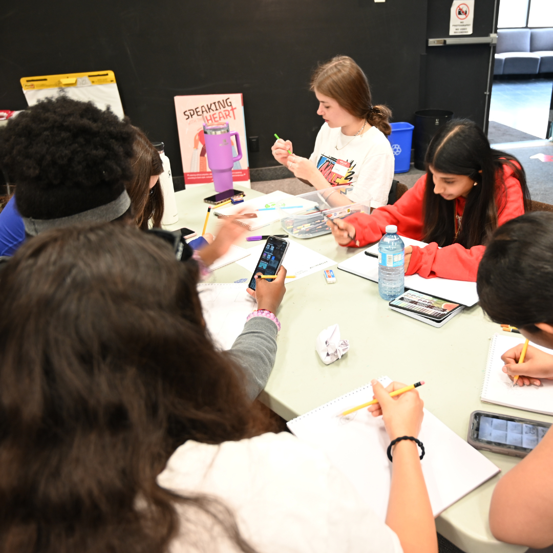 Students drawing at a table