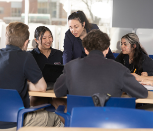 Teacher working with students