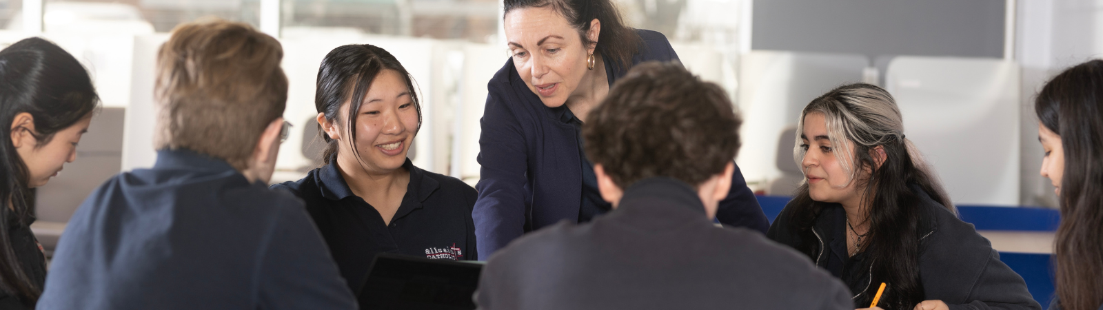 Teacher helping students